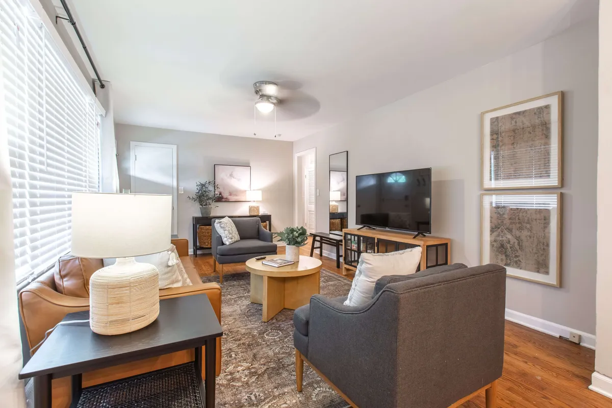 A comfortable living room with cozy seating, a coffee table, TV unit, and decorative wall art. The mood is inviting, perfect for relaxing after a day spent exploring Independence’s attractions.